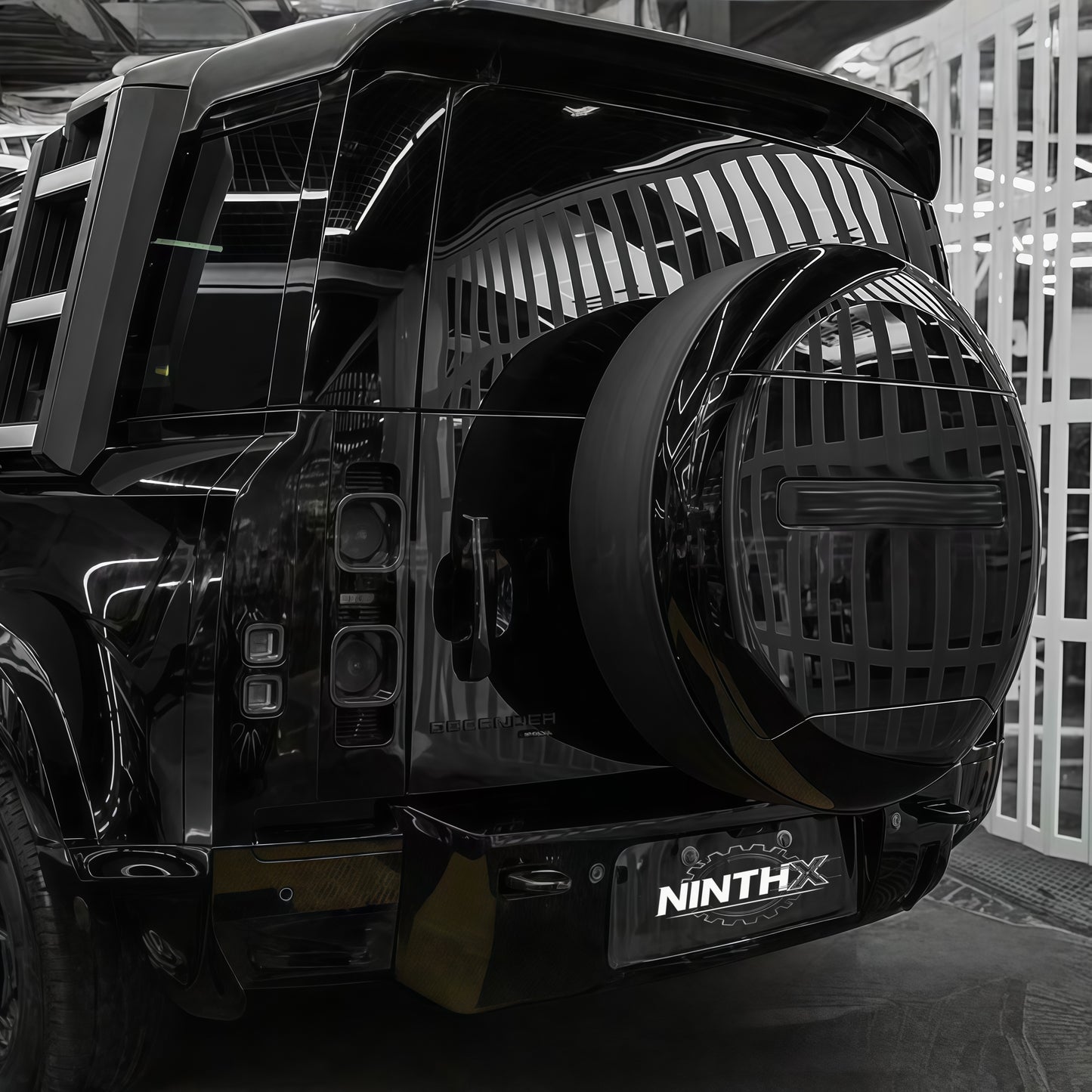 Gloss-black hard-shell spare tire cover for Defender L663 90/110/130, installed view