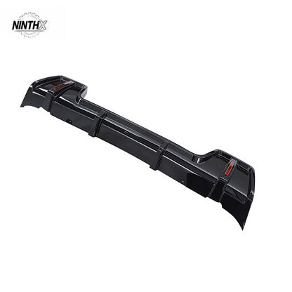 Scratch-resistant rear bumper lip spoiler, side profile