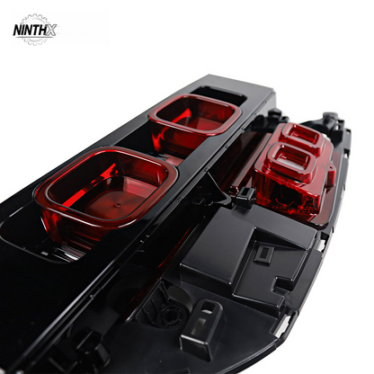 Aggressive stealth dark rear brake lamps, front angle view