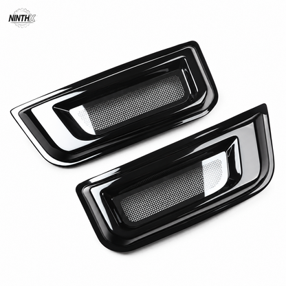 Gloss black fender air intake bug screen covers for Defender L663, shown as a pair on white.