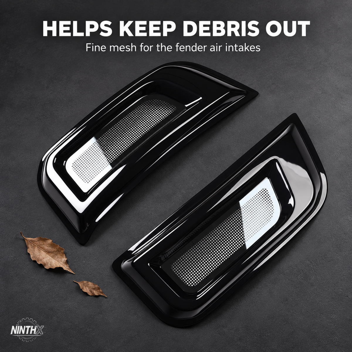 Defender L663 fender air intake bug screen covers with fine mesh, displayed beside dry leaves on a dark background.