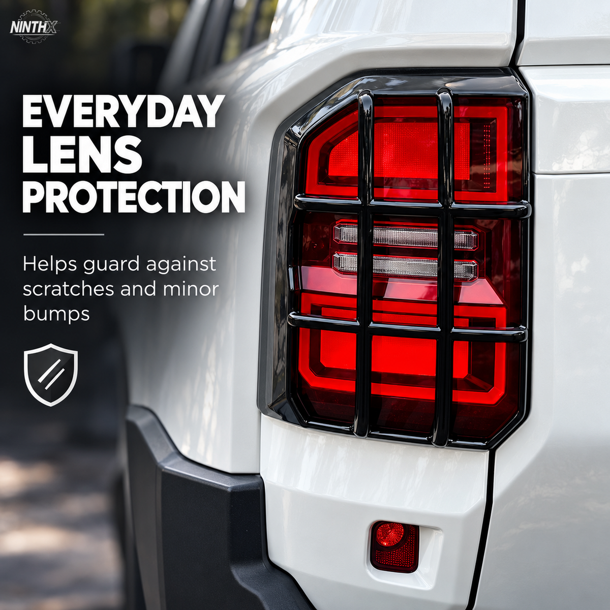 Gloss black Prado LC250 tail light guard close-up showing the open-grid lens protection design.